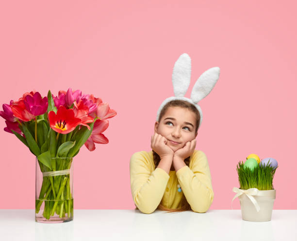 istock Dreamy girl near Easter eggs and flowers 1157085405