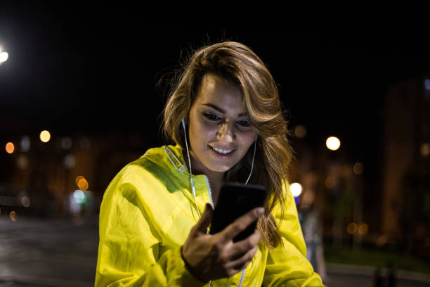 istock Satisfied young woman using mobile after she finished training 1157085594