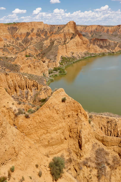 istock Red clay erosion gully and river. Eroded landscape. Spain 1157085617