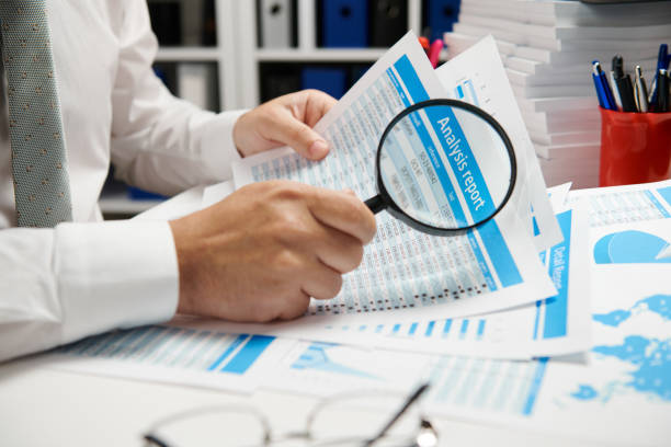 istock Businessman working and calculating, reads and writes reports. Office employee, table closeup. Business financial accounting concept. 1157085710