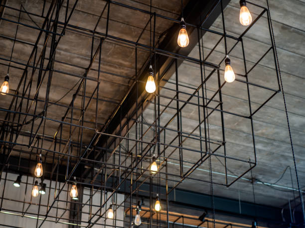 istock Modern ceiling light or light bulbs hanging from wooden ceiling in loft style building 1157085951