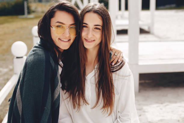 istock Two pretty girls in a summer park 1157086747