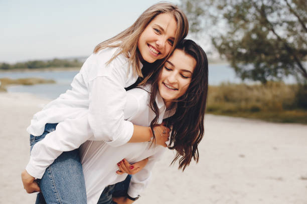 istock Two pretty girls in a summer park 1157087025