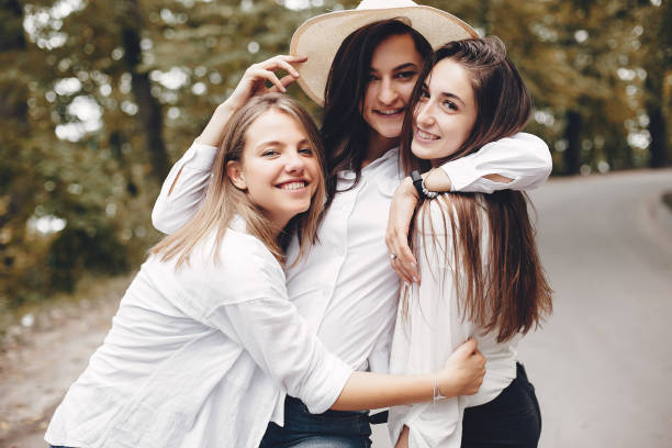 istock Three pretty girls in a summer park 1157088044