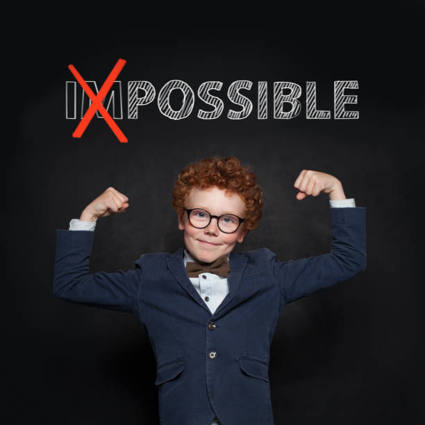 istock Confident strong child in suit with possible text on chalkboard. Success, opportunities and develop concept 1157088071