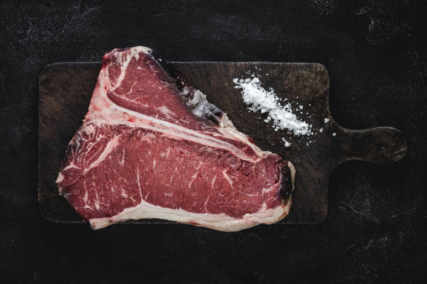 istock Raw T-bone Steak Dry Aged for Grill or BBQ on Vintage Cutting Board 1157088201