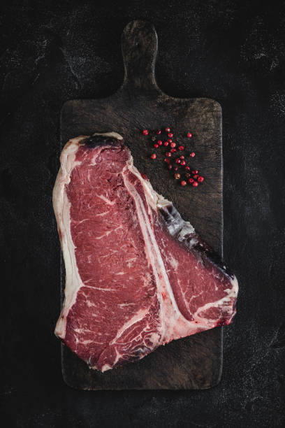 istock T-bone Steak Raw Dry Aged Beef on Vintage Cutting Board 1157088231