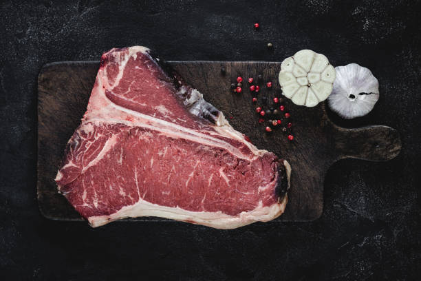 istock T-bone Steak Raw Dry Aged Beef on Vintage Cutting Board 1157088240