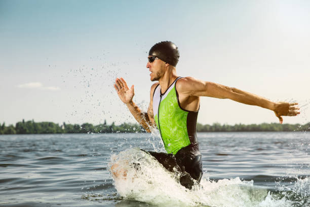 istock Professional triathlete swimming in river's open water 1157090389