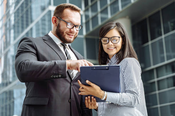istock Two successful business people smiling and discussing the project 1157091120