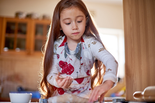 Shot of an adorable little girl baking at home