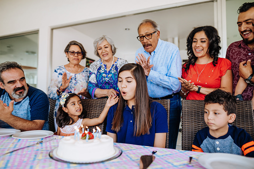 Latino family enjoys weekend together with grandparents and children.