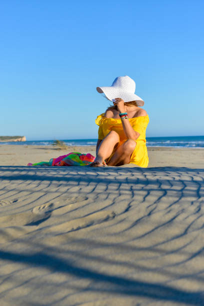 istock Woman sitting on sands. 1157092723