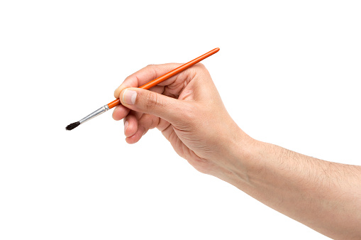 Man hand using a little paintbrush isolated on a white background
