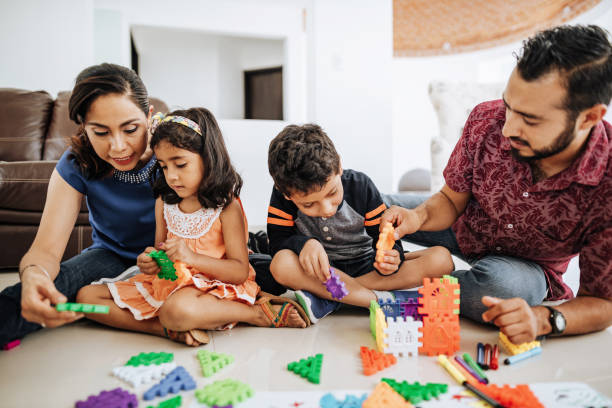 istock Latino parents playing educational games with elementary age kids. 1157093924