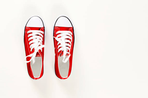 istock Red sneakers top view close up isolated on white background 1157093962