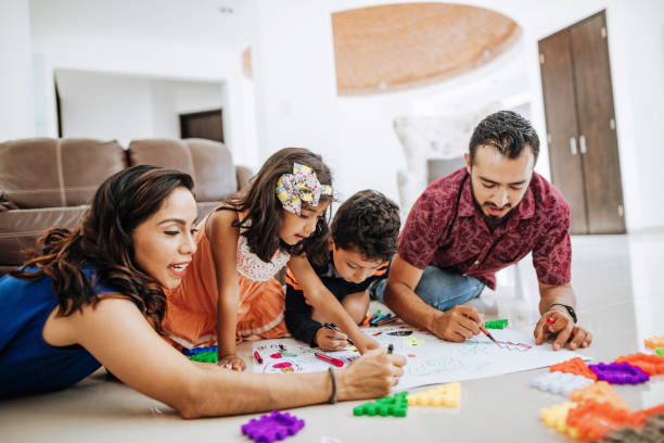 istock Latin parents playing with children at home 1157093979