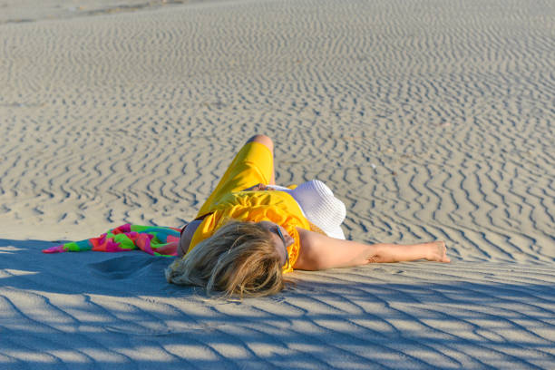 istock Woman lying on the sands. 1157094565