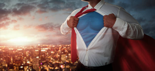 Businessman acting like a superhero Young businessman acting like a superhero and tearing his shirt off over the city at the sunset with copy space cape garment photos stock pictures, royalty-free photos & images