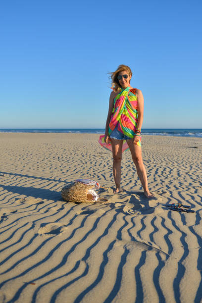Woman walking in the sand.