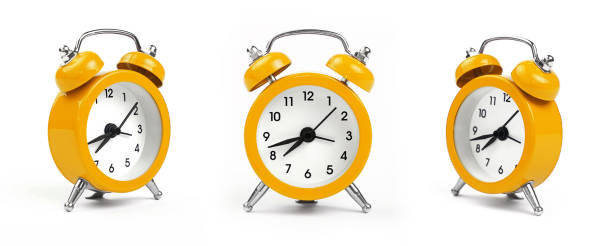 three yellow alarm clocks over white - minute hand fotos imagens e fotografias de stock