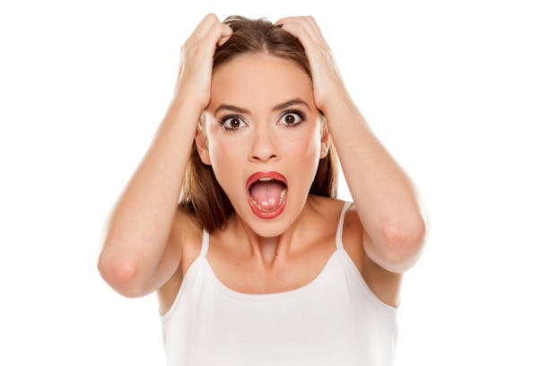 istock Beautiful shocked girl on white background 1157099055