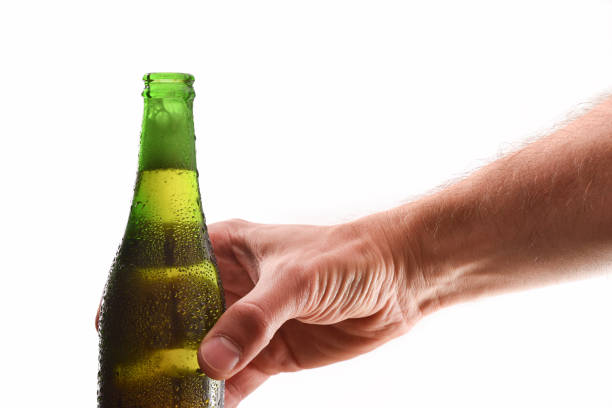 istock Hand holding bottle full of open alcoholic drink white background 1157099465