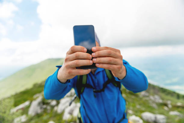 istock Young man photographing with mobile phone 1157100842