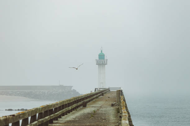 istock Pier and lighthouse in the harbour 1157101593