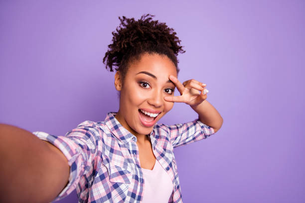 istock Close up photo nice charming satisfied millennial make v-sign eyes scream content enjoy rejoice photo travel summer checked trendy stylish top knot shirt isolated purple background free time  concept 1157101754