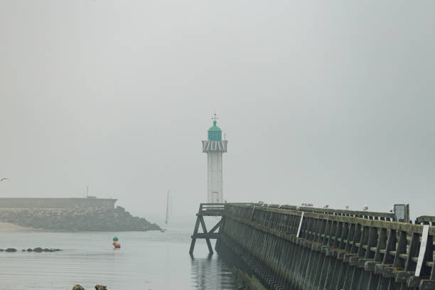 istock Pier and lighthouse in the harbour 1157101802