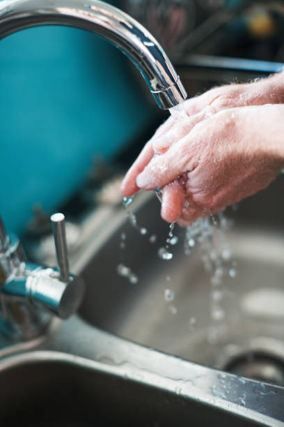 istock Hands being washed under running water at sink 1157102040