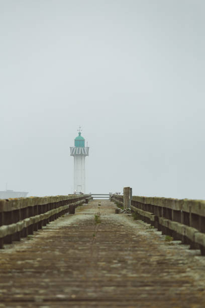istock Pier and lighthouse in the harbour 1157102332