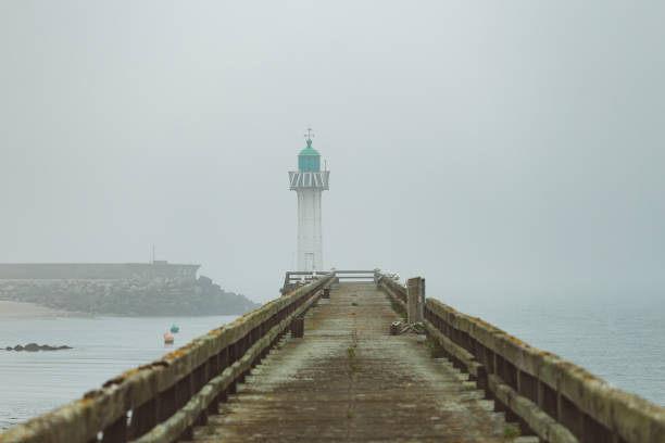 istock Pier and lighthouse in the harbour 1157102334