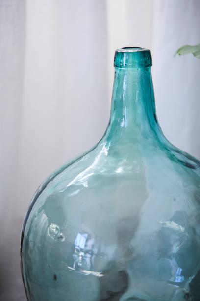 istock Glass empty vessel of unusual shape on table 1157102404