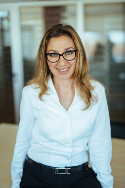 istock Smiling businesswoman in office 1157103075