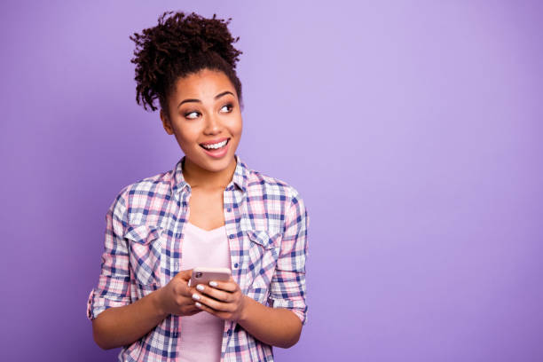 Portrait cute interested inspired hipster smm use device search information read blog blogger chatting contemplate thoughts beautiful checkered stylish trendy shirt top-knot isolated purple background Portrait cute interested inspired hipster smm use device search information read blog, blogger chatting contemplate thoughts beautiful checkered stylish trendy shirt top-knot isolated purple background black woman hair bun stock pictures, royalty-free photos & images