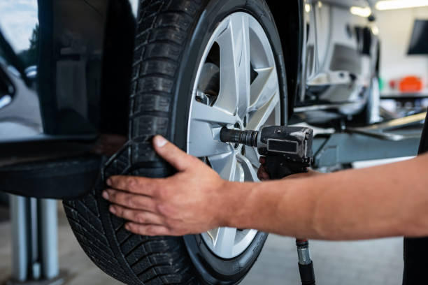 Mechanic changes a tire in a repair shop, Germany stock photo