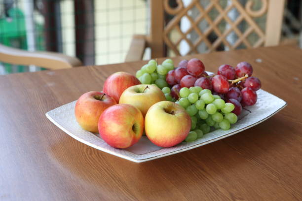 Various, colorful fruits: organic strawberries, red grapes, apples full frame.    Healthy lifestyles, dieting, healthy eating.  No people.  Directly above, high angle view.  Fruit background.