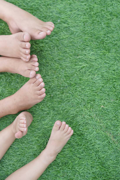 istock Legs and feet Child's on grass 1157104784