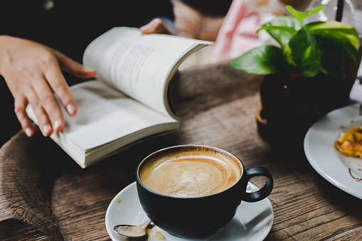 Lifestyle of student are reading textbook at coffee shop.