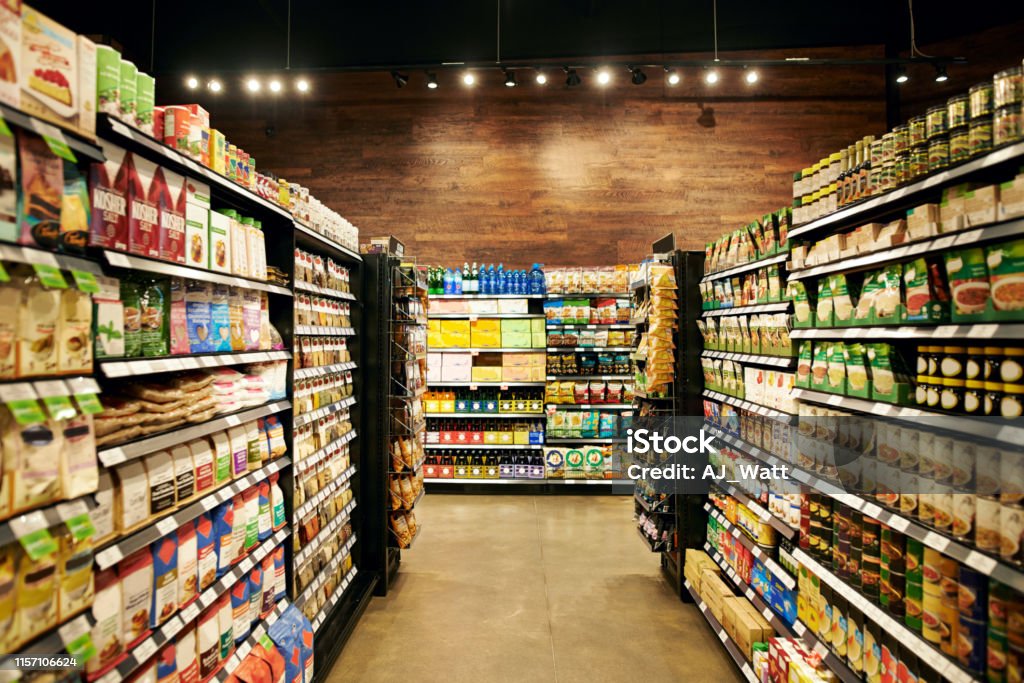 All your necessities stored in one place Shot of fully stocked isles in a grocery store during the day Supermarket Stock Photo