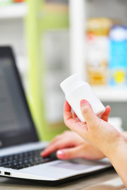istock Pharmacist using computer laptop in chemist shop for order medicine 1157106894