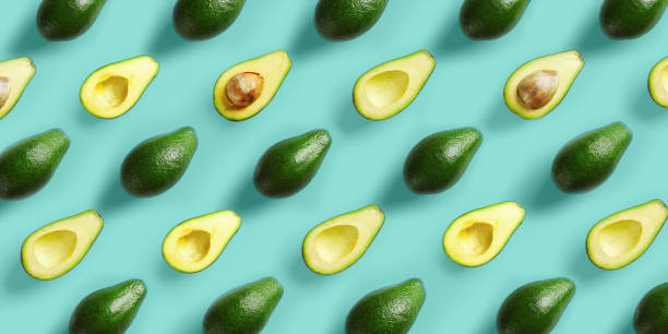 istock Avocado pattern on blue background. Pop art design, creative summer food concept. Green avocadoes, minimal flat lay style 1157109602