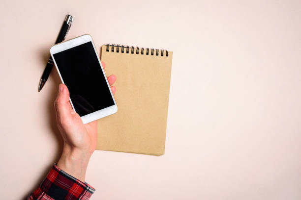 istock Man holding his phone by left hand 1157110827