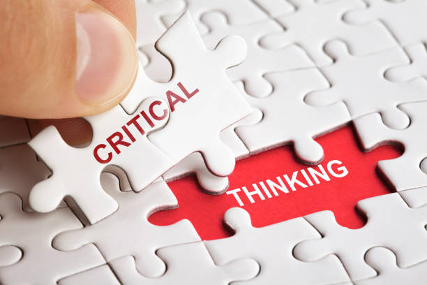 istock The human hand fills the last missing elements of the surface from the puzzle. Image with words critical and thinking 1157110844
