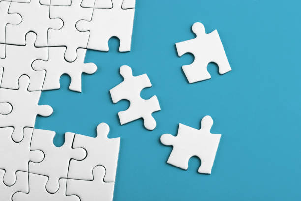 istock Closeup of the last piece of puzzle missing on blue background 1157110901