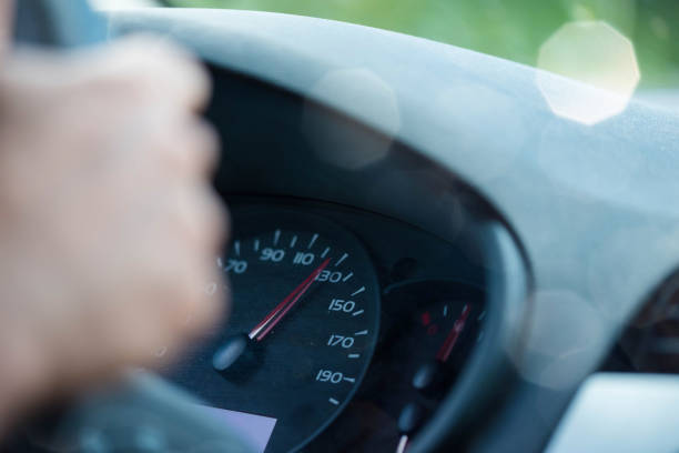 istock woman driving a car respecting speed limits 1157110920