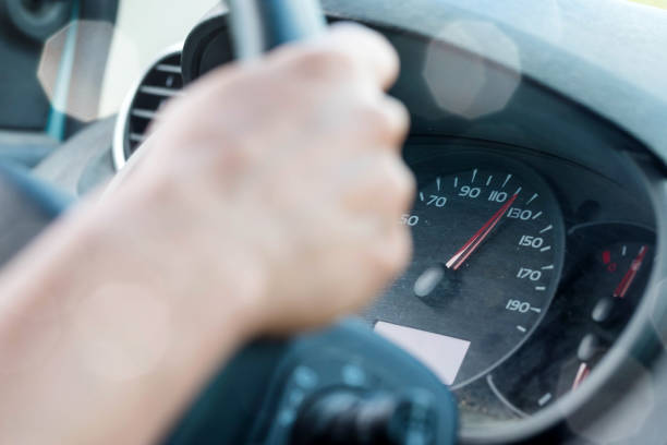 istock woman driving a car respecting speed limits 1157110921