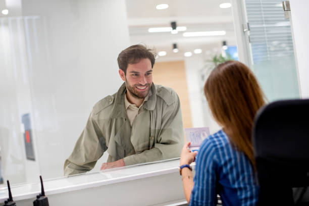 female bank teller advising  customer - bank bank teller customer banking imagens e fotografias de stock